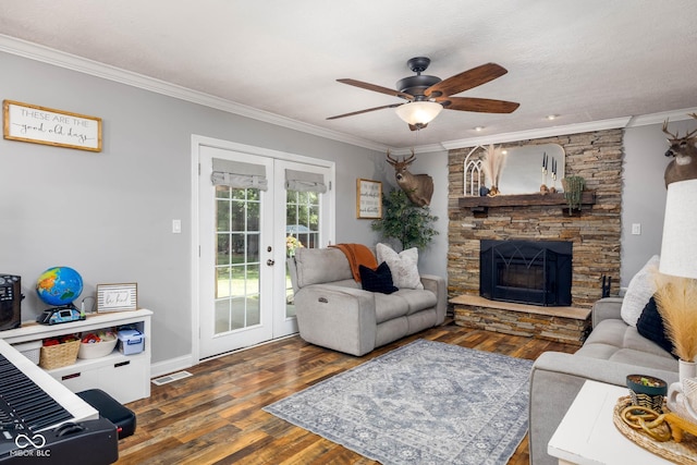 2748 S Meridian Rd, Greenfield, IN 46140 - living area with french doors, ornamental molding, a ceiling fan, wood finished floors, and a stone fireplace