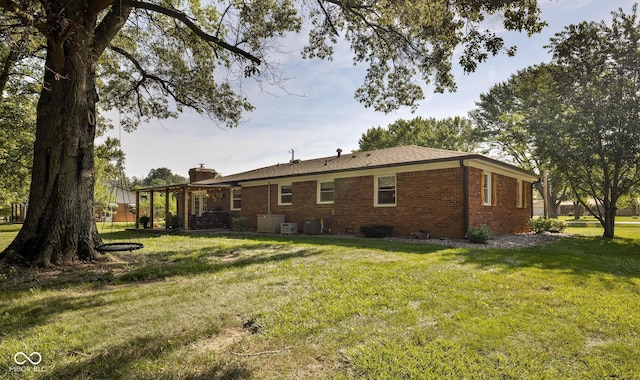 2748 S Meridian Rd, Greenfield, IN 46140 - rear view of property with brick siding, a chimney, and a lawn
