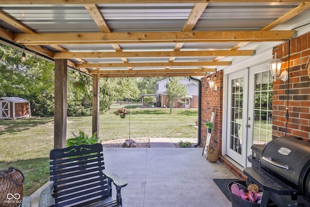 2748 S Meridian Rd, Greenfield, IN 46140 - view of patio featuring french doors, area for grilling, and a storage unit