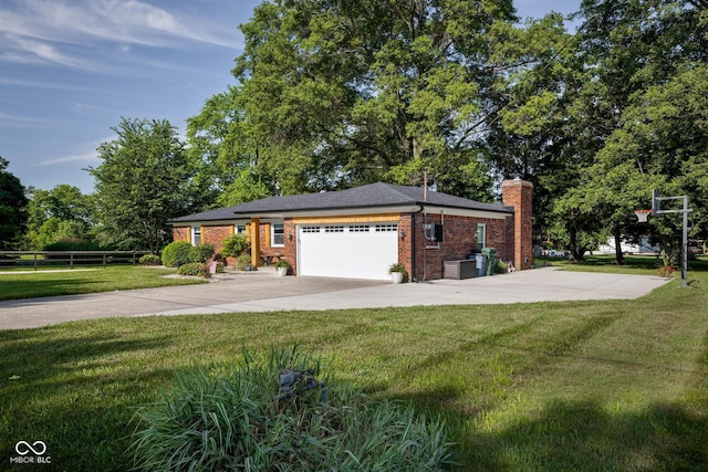 2748 S Meridian Rd, Greenfield, IN 46140 - view of front of home featuring a garage, driveway, a chimney, and brick siding
