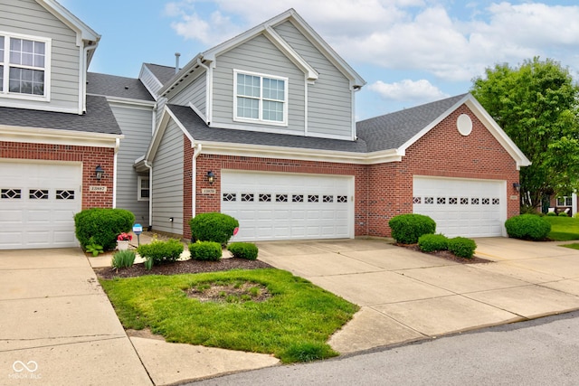 13879 Meadow Grass Way, Fishers, IN 46038 - traditional-style house featuring brick siding, a shingled roof, driveway, and a garage