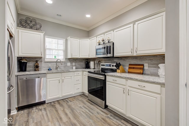 13879 Meadow Grass Way, Fishers, IN 46038 - kitchen with appliances with stainless steel finishes, recessed lighting, backsplash, white cabinets, and ornamental molding