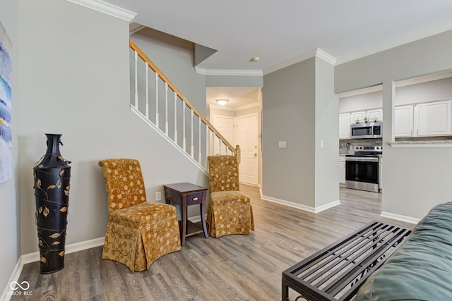13879 Meadow Grass Way, Fishers, IN 46038 - living room featuring light wood-type flooring, crown molding, and stairway