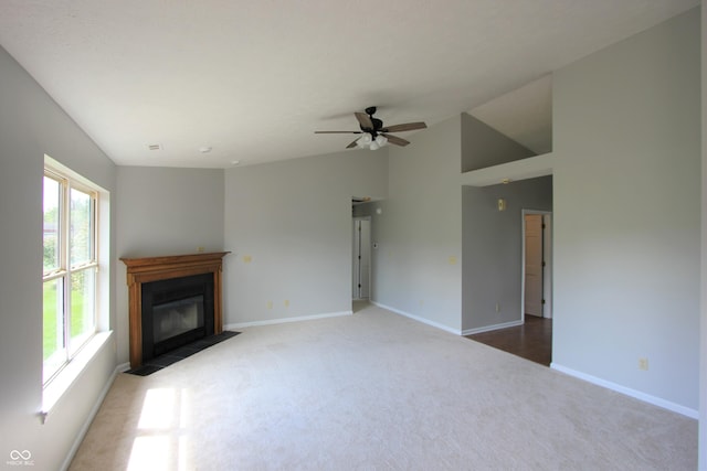 12221 Tallowtree Ct, Indianapolis, IN 46236 - unfurnished living room featuring carpet flooring, a fireplace with flush hearth, ceiling fan, and vaulted ceiling