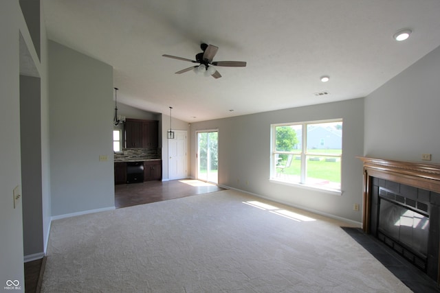 12221 Tallowtree Ct, Indianapolis, IN 46236 - unfurnished living room with a tile fireplace, dark colored carpet, lofted ceiling, and a ceiling fan