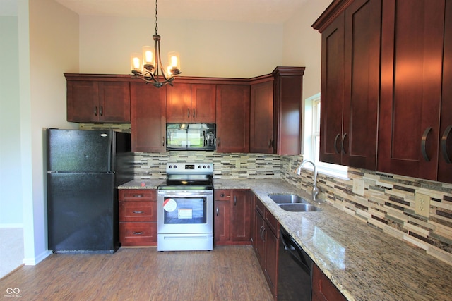 12221 Tallowtree Ct, Indianapolis, IN 46236 - kitchen with black appliances, dark wood-style flooring, a chandelier, light stone countertops, and tasteful backsplash