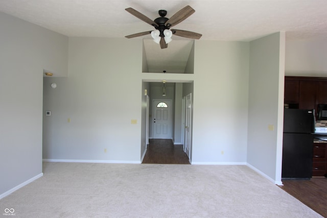 12221 Tallowtree Ct, Indianapolis, IN 46236 - unfurnished living room featuring a ceiling fan, carpet flooring, and a high ceiling