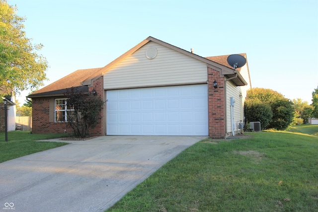 12221 Tallowtree Ct, Indianapolis, IN 46236 - view of side of property featuring brick siding, a garage, concrete driveway, and a yard