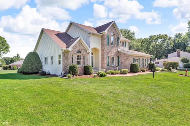3244 W Burning Tree Rd, Crawfordsville, IN 47933 - traditional-style house featuring brick siding, a front yard, and a shingled roof