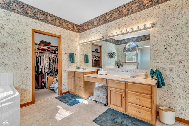 3244 W Burning Tree Rd, Crawfordsville, IN 47933 - full bathroom with double vanity, a walk in closet, a stall shower, a bath, and wallpapered walls