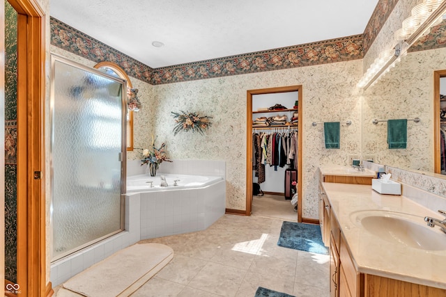3244 W Burning Tree Rd, Crawfordsville, IN 47933 - bathroom with a stall shower, a spacious closet, double vanity, a bath, and tile patterned flooring