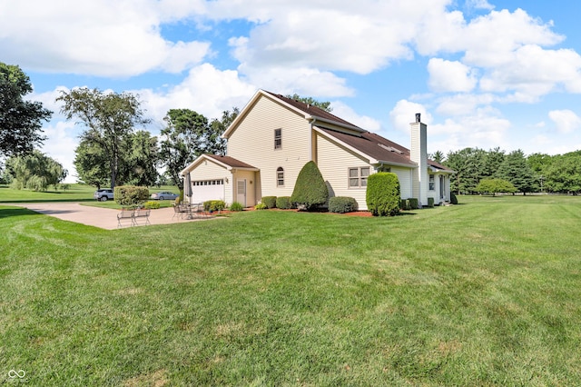 3244 W Burning Tree Rd, Crawfordsville, IN 47933 - view of side of home with a chimney, a lawn, driveway, and a garage