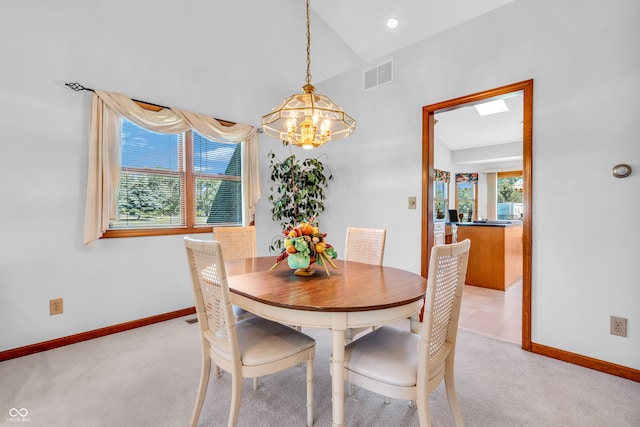 3244 W Burning Tree Rd, Crawfordsville, IN 47933 - dining space with a chandelier, vaulted ceiling, and light carpet