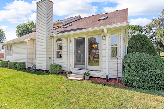 3244 W Burning Tree Rd, Crawfordsville, IN 47933 - back of property with a chimney, a lawn, and roof with shingles