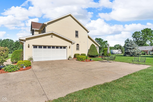 3244 W Burning Tree Rd, Crawfordsville, IN 47933 - view of property exterior with driveway, a lawn, and a garage