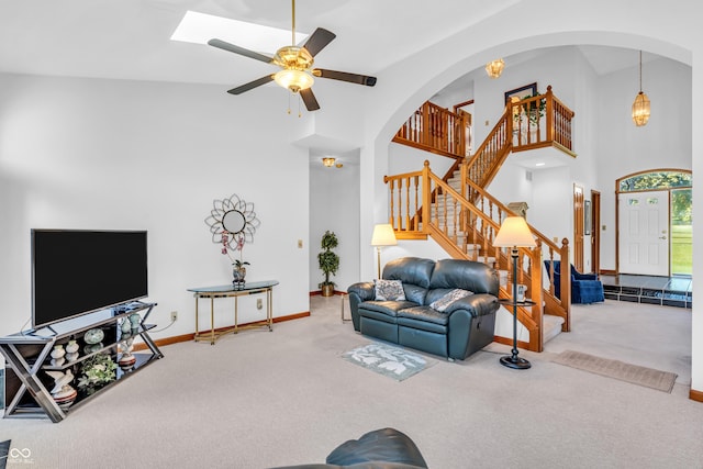 3244 W Burning Tree Rd, Crawfordsville, IN 47933 - carpeted living area with a high ceiling, stairs, ceiling fan, and arched walkways