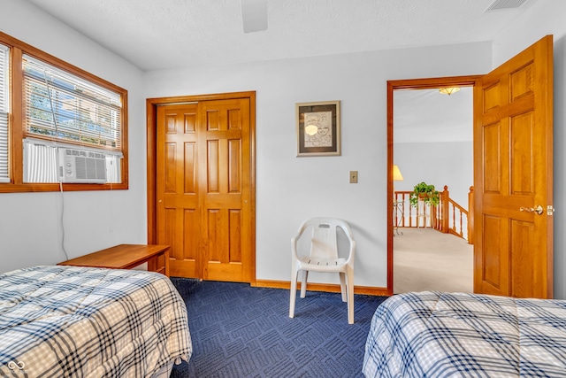3244 W Burning Tree Rd, Crawfordsville, IN 47933 - bedroom featuring dark carpet, cooling unit, a closet, ceiling fan, and a textured ceiling