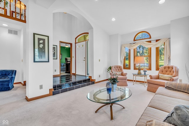 3244 W Burning Tree Rd, Crawfordsville, IN 47933 - carpeted living area featuring arched walkways, recessed lighting, and a high ceiling