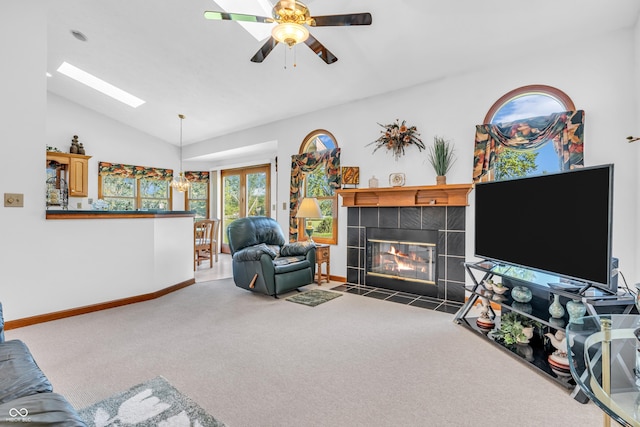 3244 W Burning Tree Rd, Crawfordsville, IN 47933 - living room featuring vaulted ceiling, carpet, a tiled fireplace, ceiling fan, and a skylight