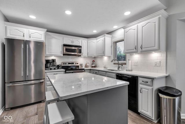 1006 Barry Dr, Lebanon, IN 46052 - kitchen with stainless steel appliances, light wood finished floors, light stone counters, white cabinets, and recessed lighting