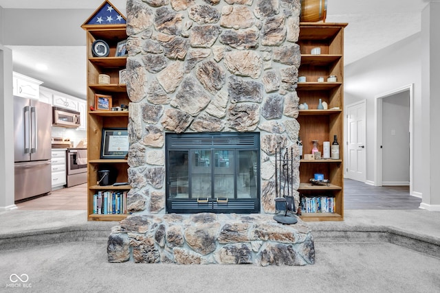 1006 Barry Dr, Lebanon, IN 46052 - carpeted living room with a stone fireplace and wood finished floors