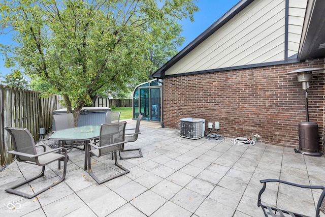 1006 Barry Dr, Lebanon, IN 46052 - fenced backyard with outdoor dining area, a patio, and a covered hot tub
