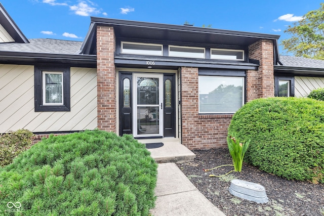 1006 Barry Dr, Lebanon, IN 46052 - property entrance featuring roof with shingles and brick siding