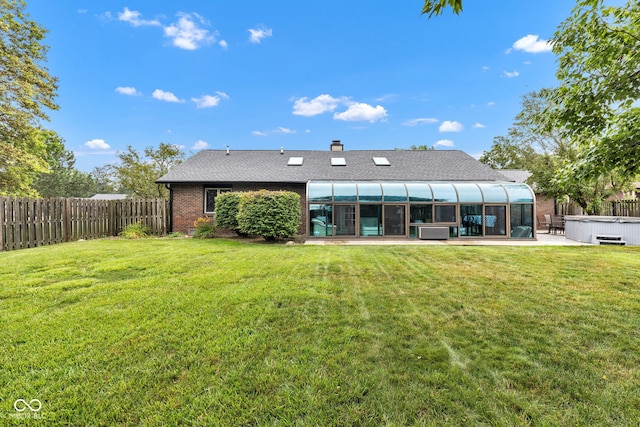 1006 Barry Dr, Lebanon, IN 46052 - back of property featuring a hot tub, a sunroom, a fenced backyard, a chimney, and brick siding