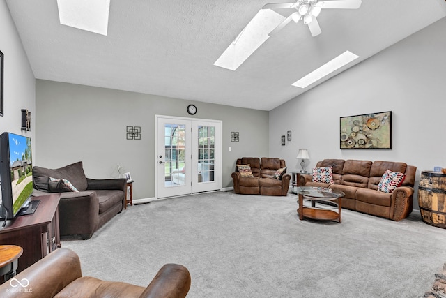 1006 Barry Dr, Lebanon, IN 46052 - carpeted living room featuring a skylight, ceiling fan, and lofted ceiling
