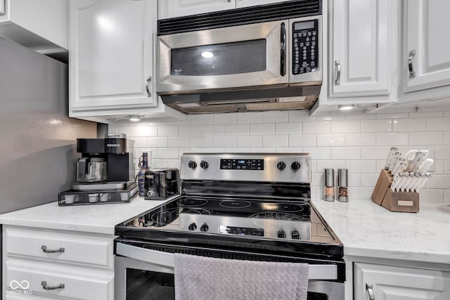 1006 Barry Dr, Lebanon, IN 46052 - kitchen featuring appliances with stainless steel finishes, white cabinets, and backsplash