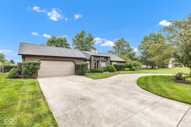 1006 Barry Dr, Lebanon, IN 46052 - view of front facade with driveway, an attached garage, brick siding, a shingled roof, and a chimney