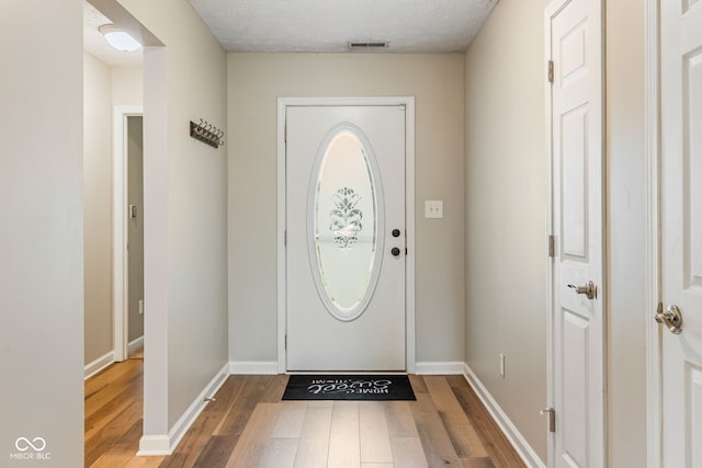 14098 Mimosa Ct, Fishers, IN 46038 - foyer entrance with wood-type flooring and a textured ceiling