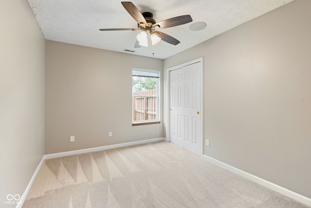 14098 Mimosa Ct, Fishers, IN 46038 - unfurnished bedroom with light colored carpet, a closet, a textured ceiling, and ceiling fan