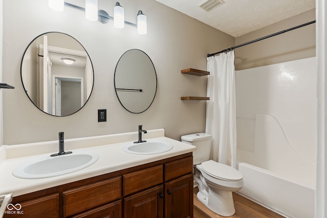 14098 Mimosa Ct, Fishers, IN 46038 - bathroom featuring double vanity, shower / bath combo with shower curtain, wood finished floors, and a textured ceiling