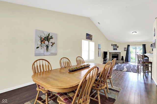 6417 Meadowpond Way, Indianapolis, IN 46235 - dining area with lofted ceiling, dark wood finished floors, and a brick fireplace