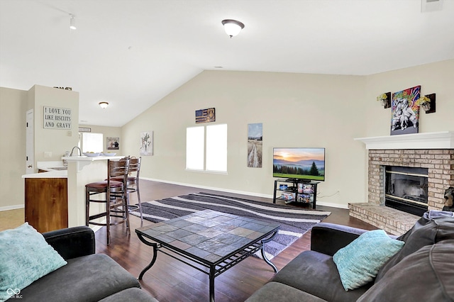 6417 Meadowpond Way, Indianapolis, IN 46235 - living area featuring dark wood-type flooring, lofted ceiling, and a brick fireplace