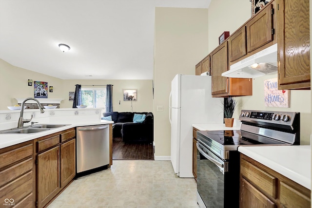 6417 Meadowpond Way, Indianapolis, IN 46235 - kitchen with appliances with stainless steel finishes, under cabinet range hood, light countertops, and brown cabinetry