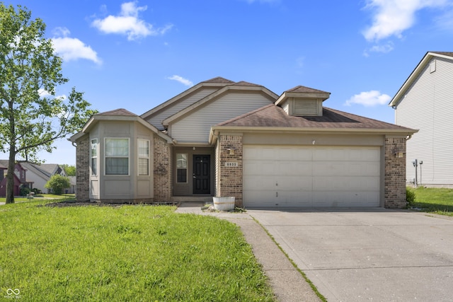 6933 Lohr Way, Indianapolis, IN 46214 - view of front of property featuring brick siding, an attached garage, driveway, and a front yard
