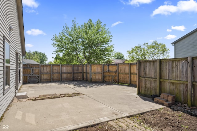 6933 Lohr Way, Indianapolis, IN 46214 - fenced backyard featuring a patio area and a gate
