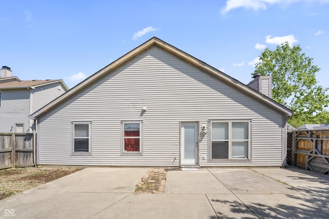 6933 Lohr Way, Indianapolis, IN 46214 - rear view of property with a patio and a chimney