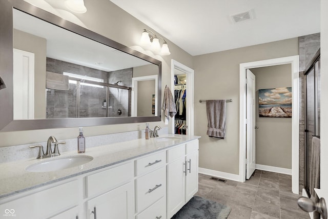10490 Cleary Trace Dr, Fishers, IN 46040 - bathroom featuring a stall shower, double vanity, and a spacious closet