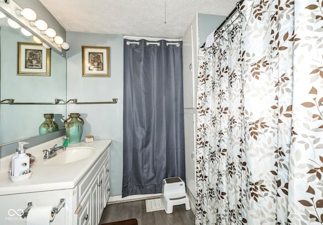 21 N Tremont St, Indianapolis, IN 46222 - bathroom featuring vanity, a textured ceiling, wood finished floors, and curtained shower