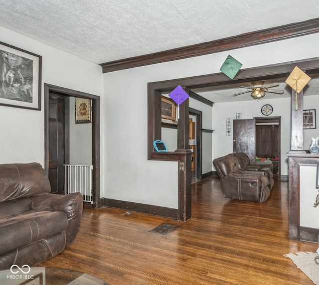 21 N Tremont St, Indianapolis, IN 46222 - living room featuring wood finished floors, a ceiling fan, a textured ceiling, ornamental molding, and radiator