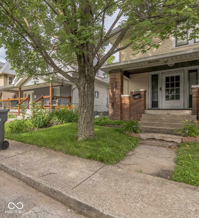 21 N Tremont St, Indianapolis, IN 46222 - view of front facade featuring a porch and brick siding