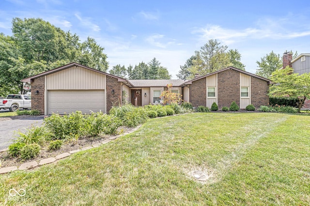 11329 Moss Dr, Carmel, IN 46033 - view of front of home featuring brick siding, driveway, a garage, and a front yard