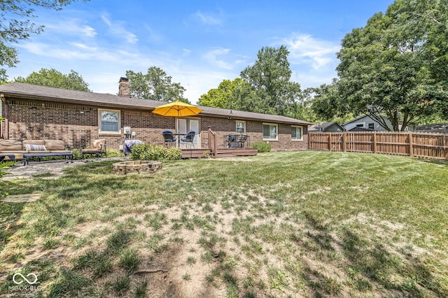 11329 Moss Dr, Carmel, IN 46033 - back of house featuring brick siding, a fenced backyard, a chimney, and a deck
