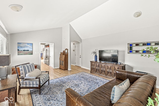 11329 Moss Dr, Carmel, IN 46033 - living area featuring vaulted ceiling, wood finished floors, and arched walkways
