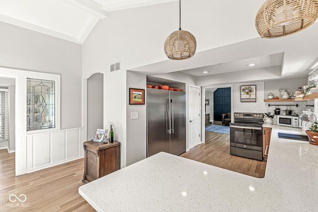 11329 Moss Dr, Carmel, IN 46033 - kitchen with stainless steel appliances, light wood finished floors, decorative backsplash, open shelves, and light stone counters