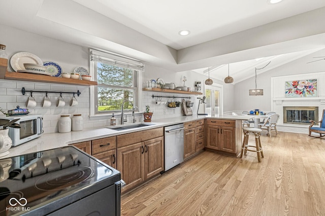11329 Moss Dr, Carmel, IN 46033 - kitchen with dishwasher, open shelves, range with electric stovetop, vaulted ceiling, and brown cabinetry