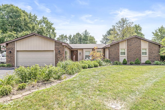 11329 Moss Dr, Carmel, IN 46033 - view of front facade featuring a garage, a front yard, brick siding, and driveway